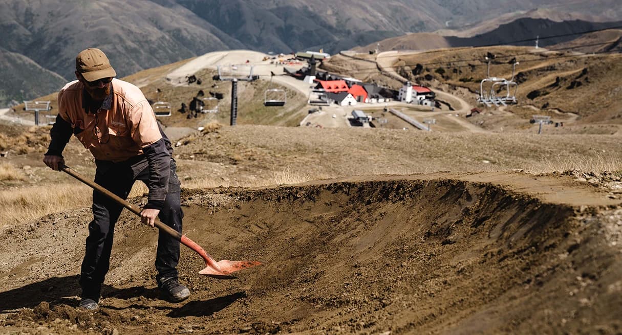 A staff member builds a trail within the Cardrona Bike Park.