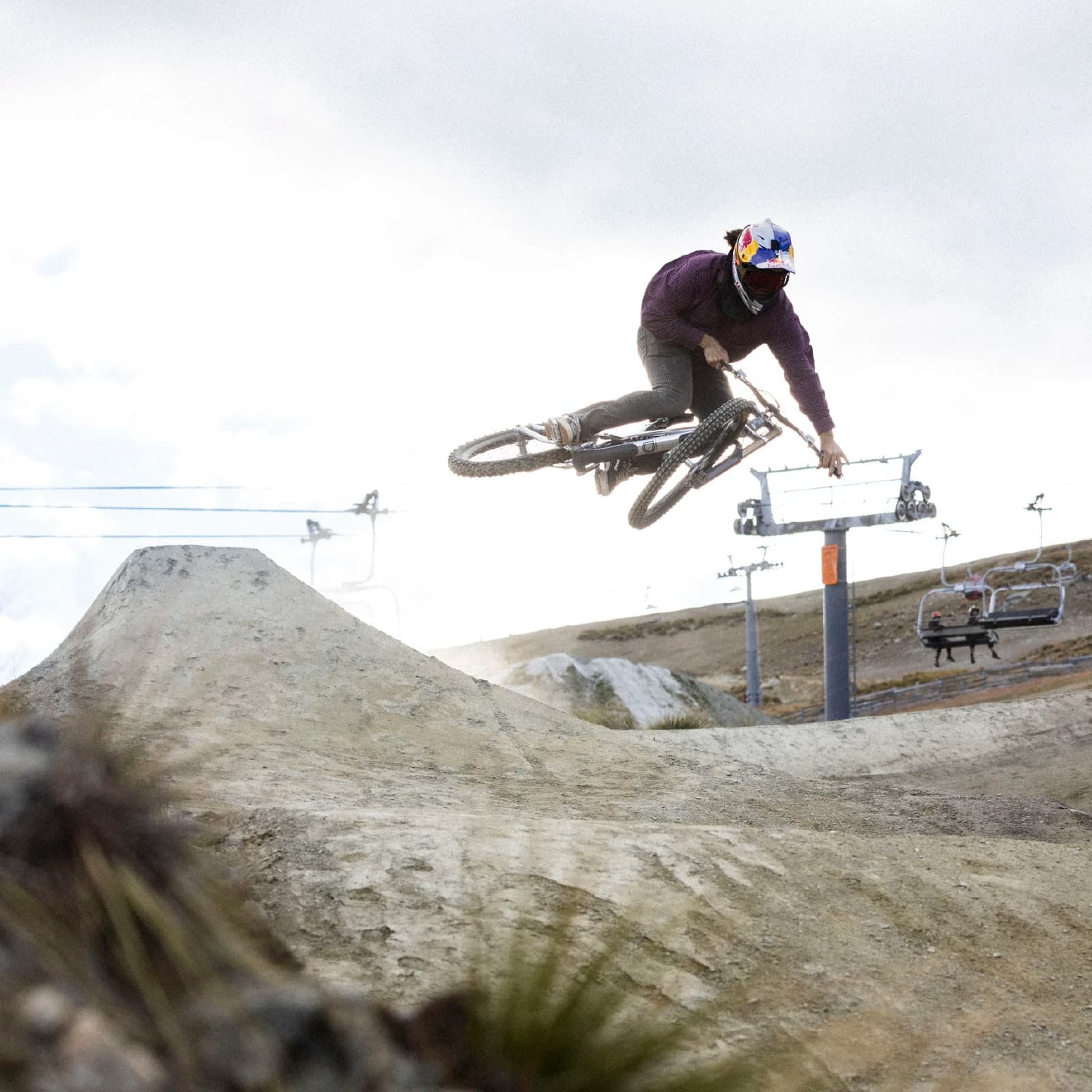 A person whips their bike to the side as they hit a jump in the Cardrona bike park.