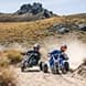 Two people race around a corner whilst Mountain Carting at Cardrona.