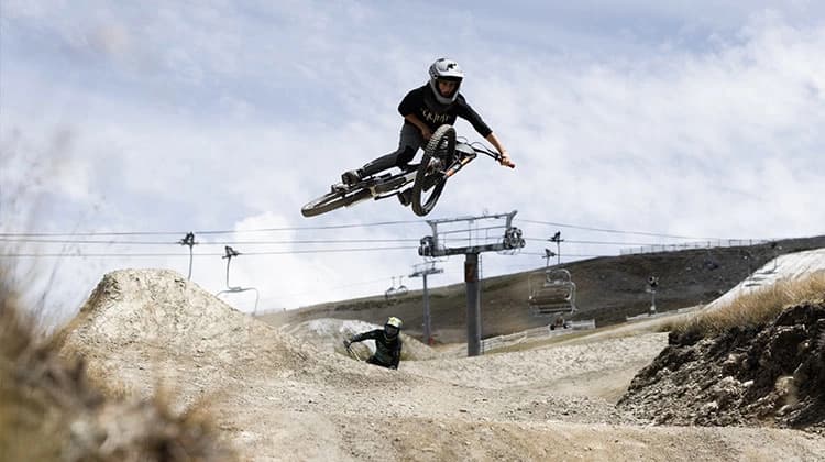 A person whips there bike to the side as the do a jump in the Cardrona bike park.