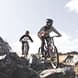 Two people ride through a rocky feature in the Cardrona Bike Park.