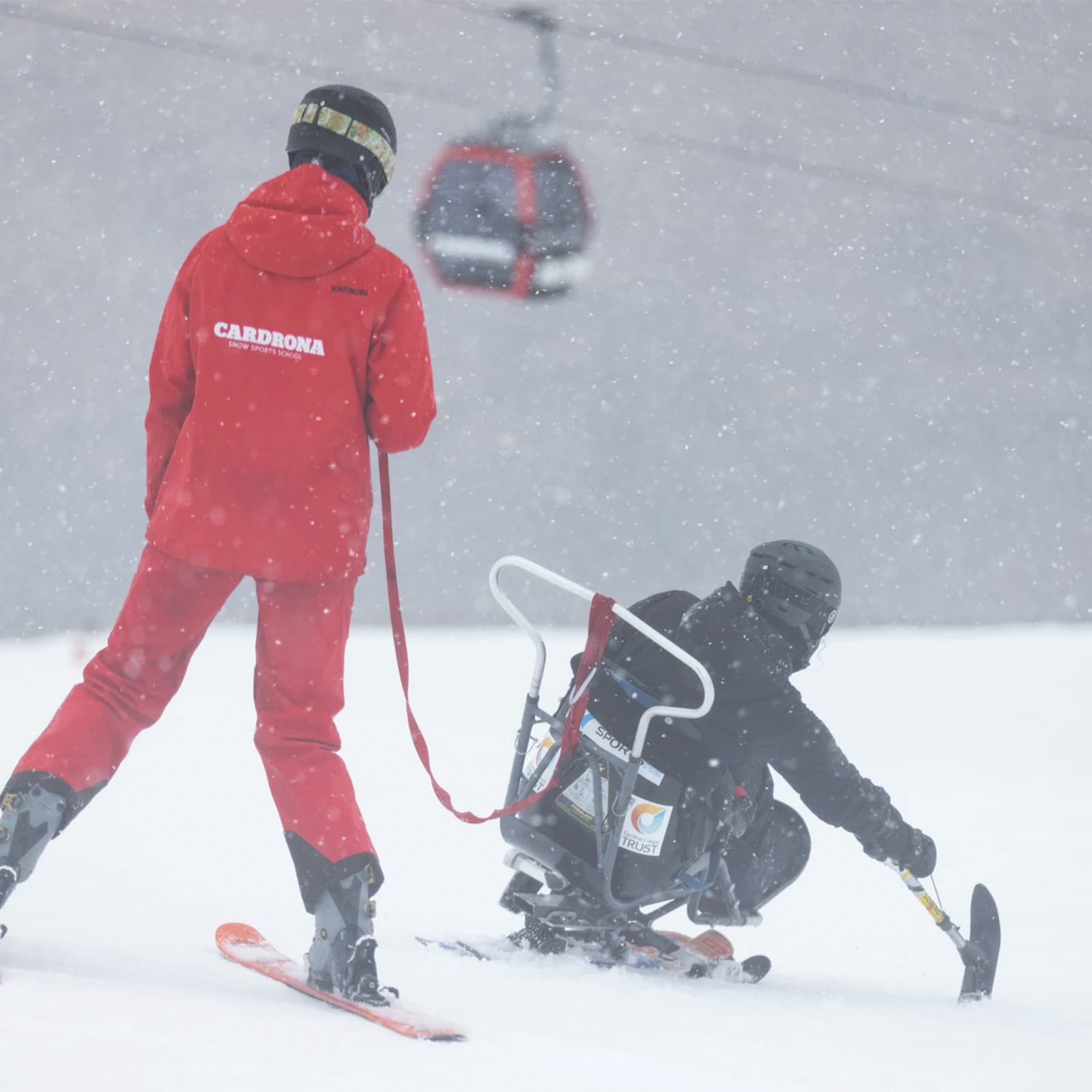 A Cardrona Ski Instructor follows a guest down on an adaptive skiing lesson.