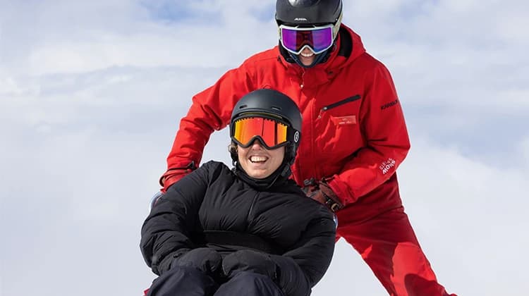 A lady enjoys an adaptive skiing lesson at Cardrona Alpine Resort.