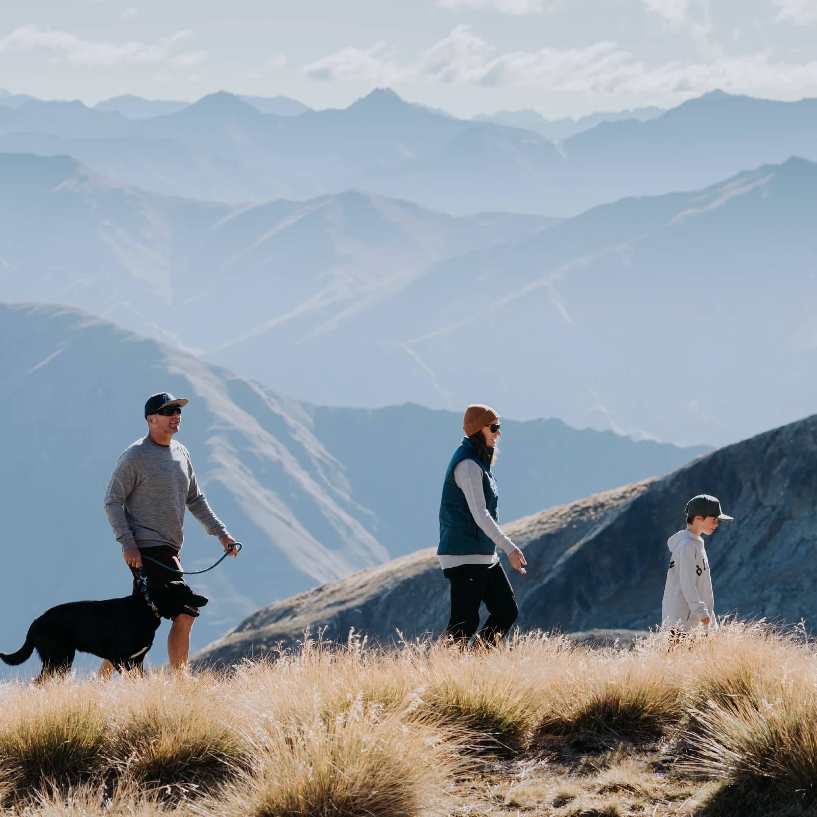 A family goes for a walk with their dog at Cardrona.