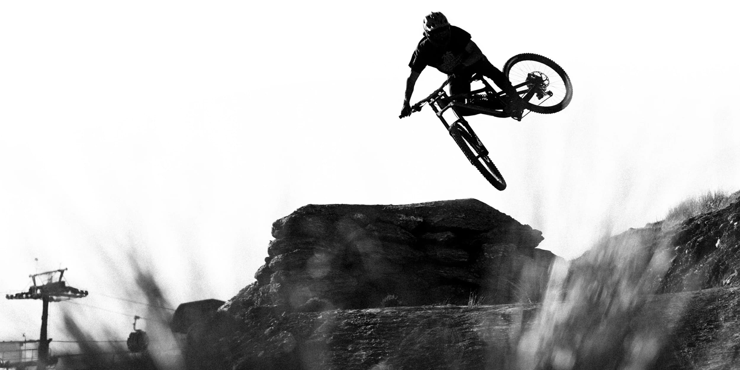 A person rides over a large jump at the Cardrona bike park.