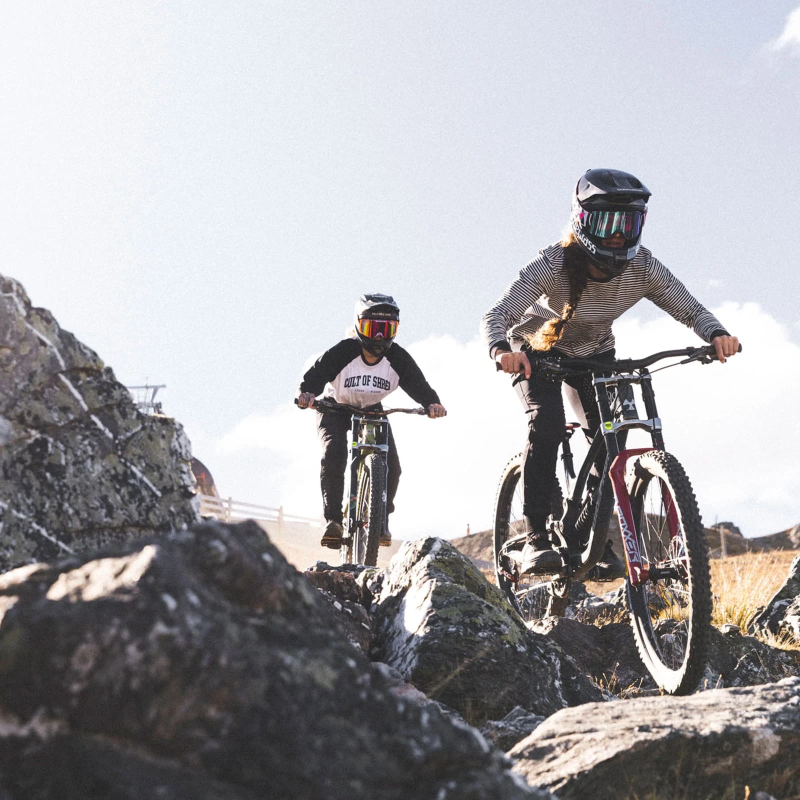 Two friends ride down a technical section at the Cardrona bike park.