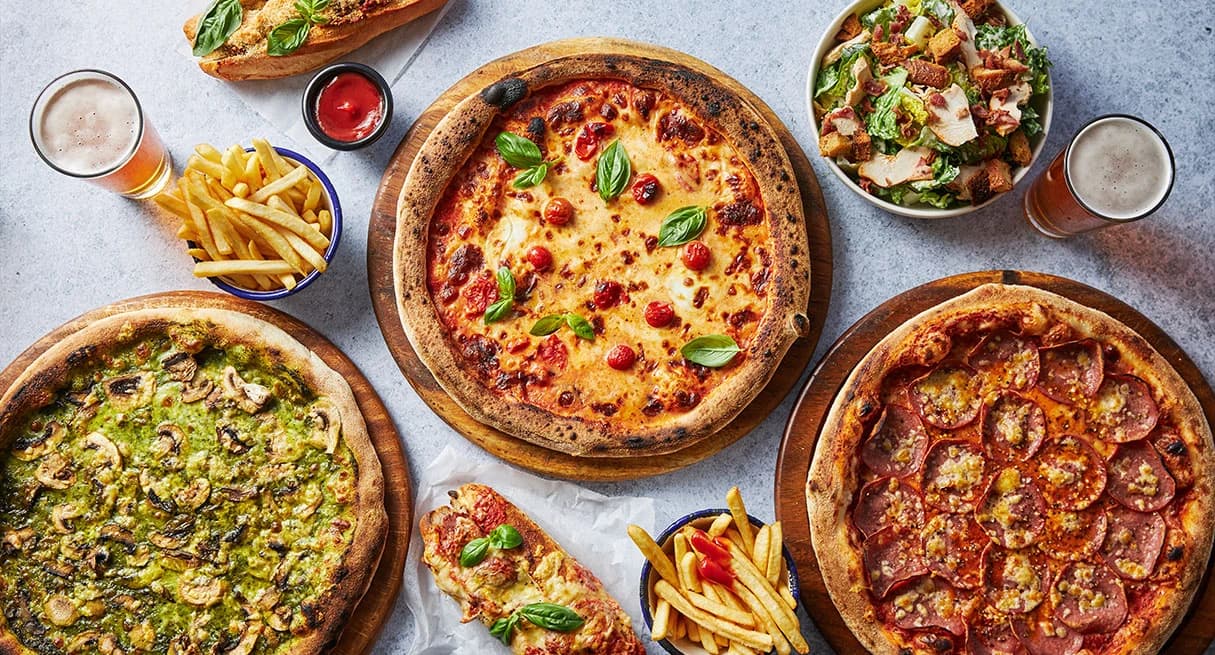 A selection of delicious pizzas and fries.