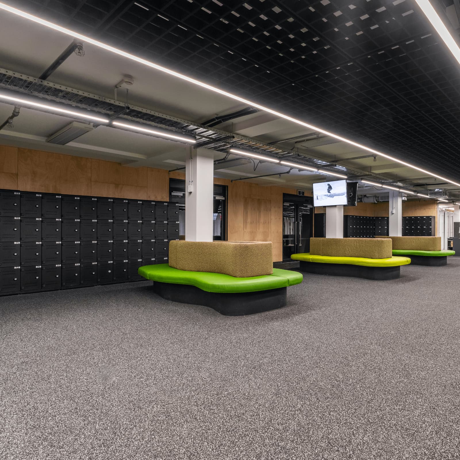 Fitting area with seats and a back wall of lockers.