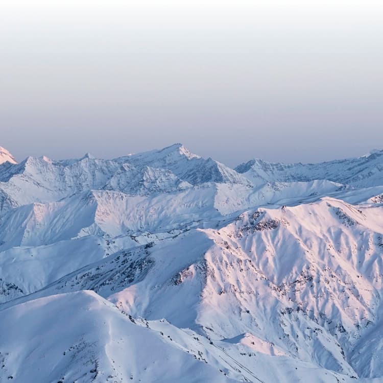 Snow-capped mountains for as far as the eye can see at the top of the Cardrona ski field.